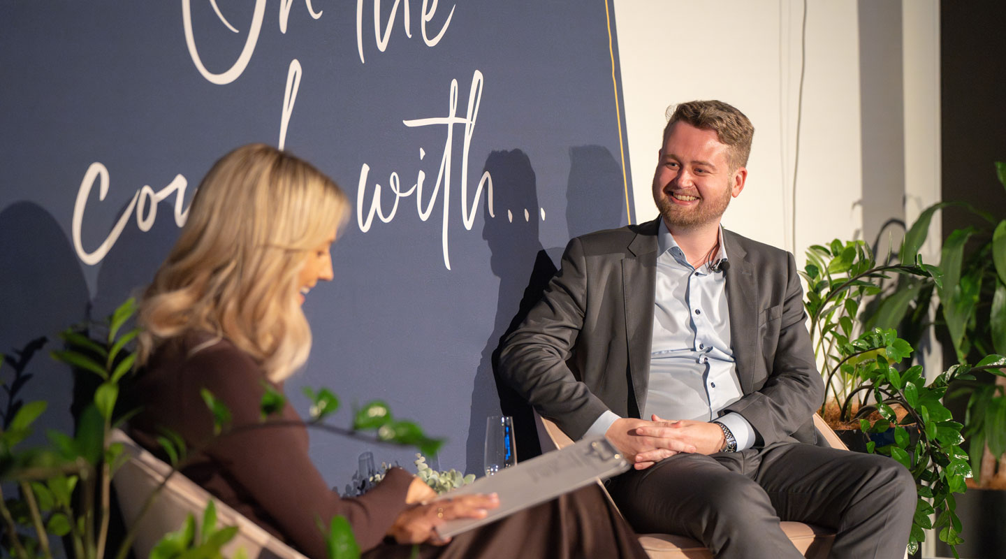 Jack Hutchinson smiling towards On The Couch host